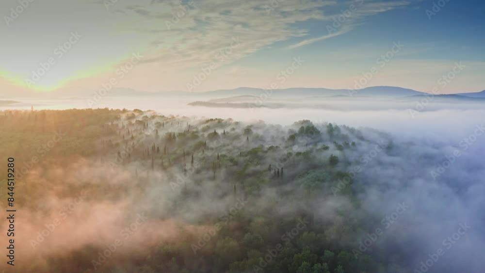 Amazing sunrise over mountain forest covered by haze. Morning fog hiding forest Amazing sunrise over mountain forest covered by haze. Morning fog hiding forest