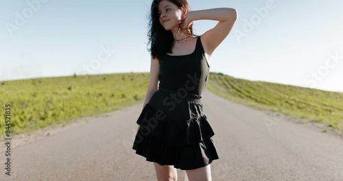 Attractive caucasian woman on roller skates posing outdoor in sunny day.