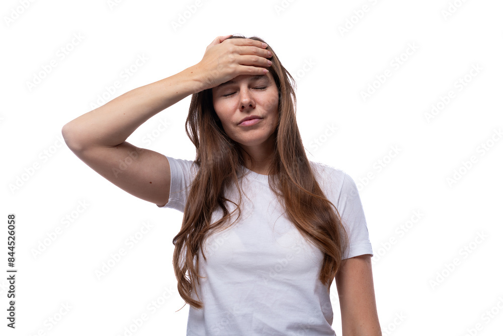 A young woman of European appearance is puzzled and holds her head A young woman of European appearance is puzzled and holds her head