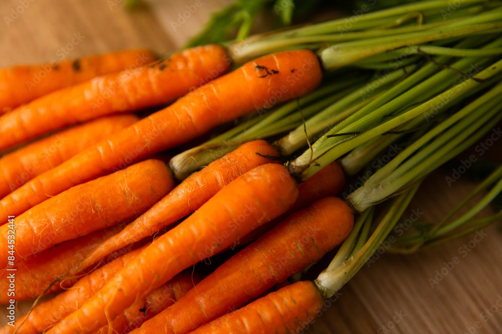 low key close up of baby carrots on a board low key close up of baby carrots on a board