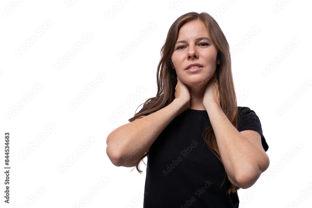 Brown haired woman with straight hair wearing a basic t-shirt against a copy space background Brown haired woman with straight hair wearing a basic t-shirt against a copy space background