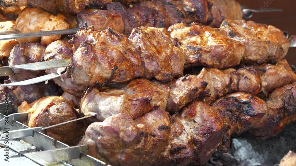 Grilled meat. Hot kebabs. Meat are cooked on hot coals in chargrill. Smoke from hot coals. Shish kebabs broils in barbecue Grilled meat. Hot kebabs. Meat are cooked on hot coals in chargrill. Smoke from hot coals. Shish kebabs broils in barbecue