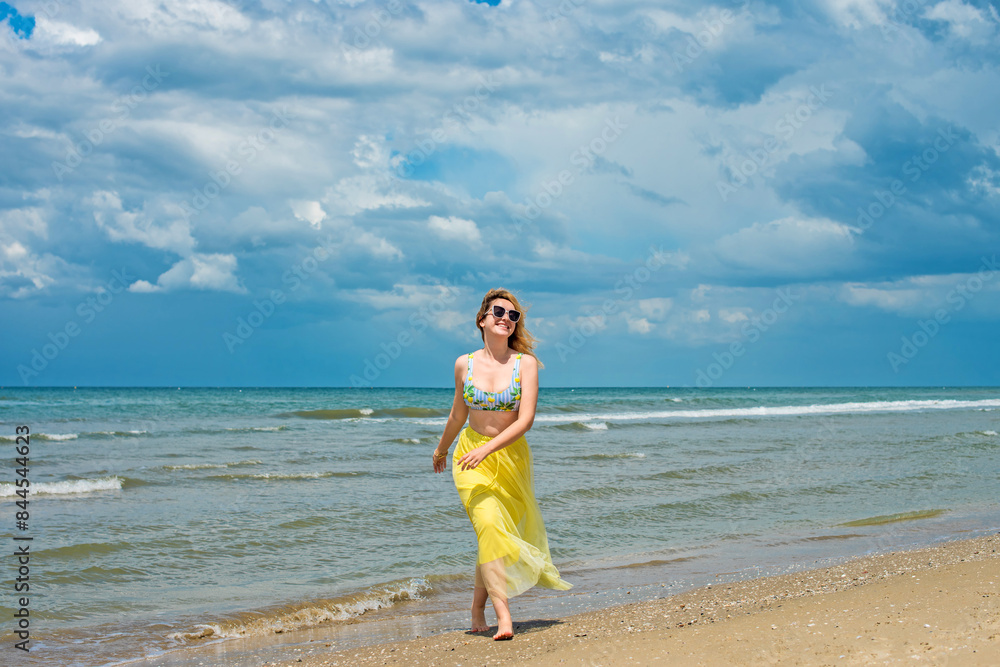 Concept of beach recreation, vacation time at warm climate. Girl on a sunny day at sea Concept of beach recreation, vacation time at warm climate. Girl on a sunny day at sea