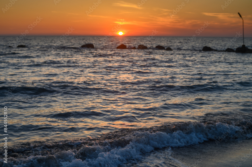 Naklejka premium beautiful golden sunset on the Mediterranean coast on the island of Cyprus 1