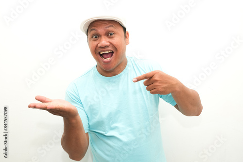 Attractive Asian man smiling while pointing to his open hand palm photo