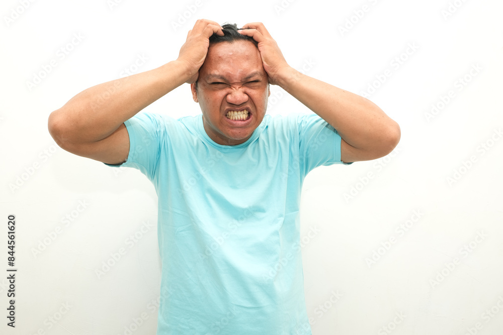 asian man feeling headache isolated on white background
asian man feeling headache isolated on white background