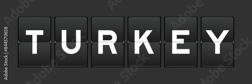 Black color analog flip board with word turkey on gray background