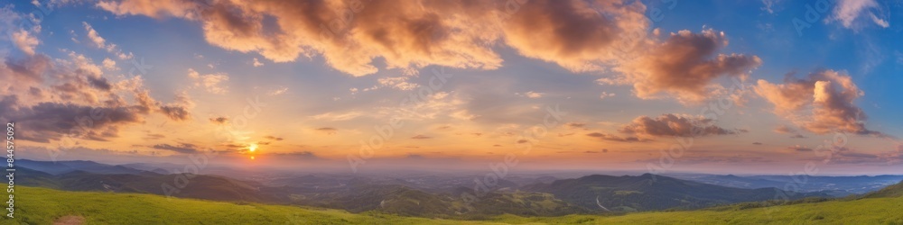 Fototapeta premium Sunset over the green hills and valleys