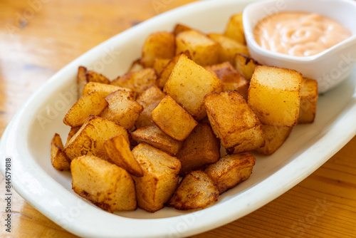 patatas bravas (spicy potatoes) A ​​traditional snack in Spain consisting of baked or boiled potatoes dipped in sauce, Spanish Cuisine