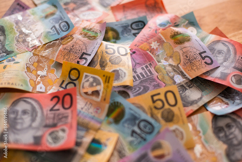 pile of aussie dollar notes with a mix of twenties, tens, fifties and fives photo