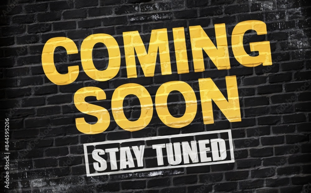 Obraz premium A coming soon announcement with large yellow text on a black brick wall background, with the text 