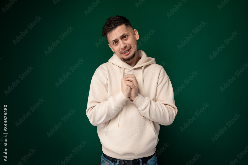 Man Standing in Front of Green Background