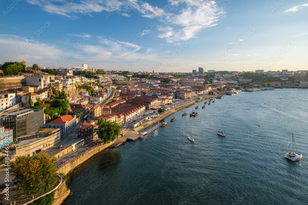 Fototapeta premium View of Vila Nova de Gaia city and Douro river with tourist boats on sunset. Porto, , Portugal
