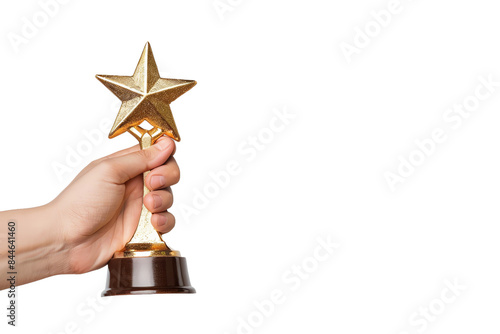 A hand holding a golden star-shaped trophy, symbolizing achievement and success. photo