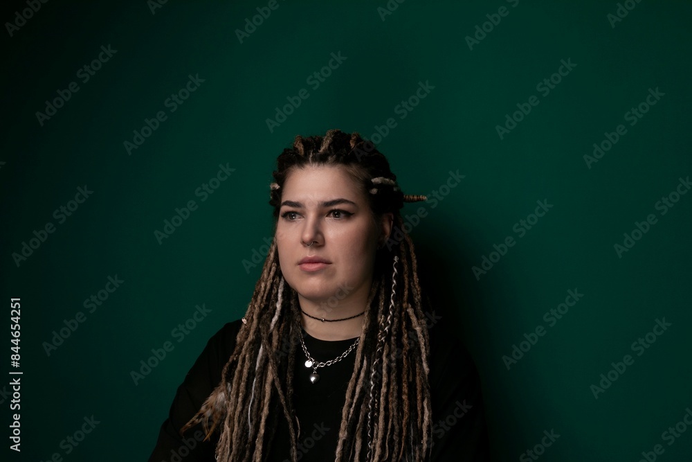 Woman With Dreadlocks in Front of Green Wall Woman With Dreadlocks in Front of Green Wall