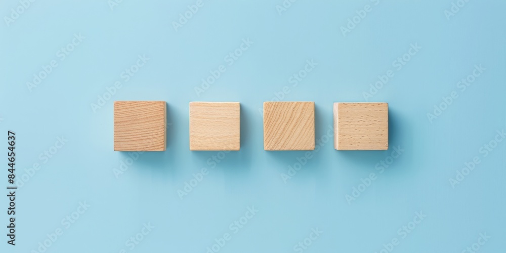 Wooden cubes in a row on a blue background, perfect for minimalistic and modern design themes. Wooden cubes in a row on a blue background, perfect for minimalistic and modern design themes.