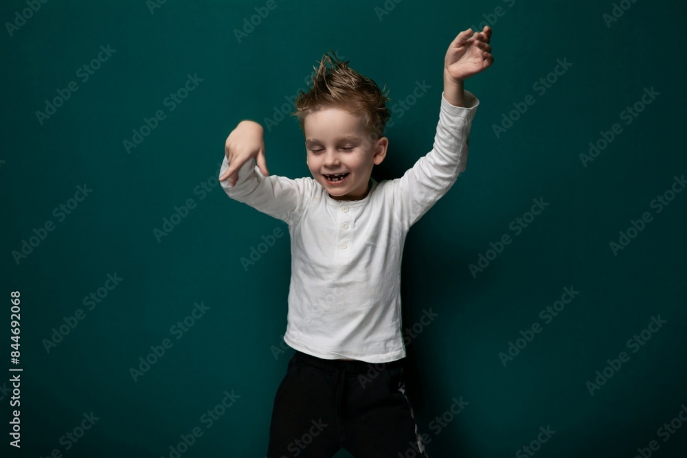 Young Boy Standing in Front of Green Wall Young Boy Standing in Front of Green Wall