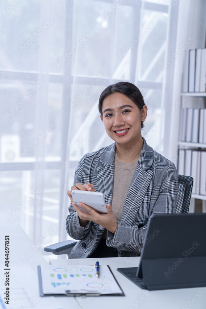 Bussiness women using laptop and smartphone working in the office Bussiness women using laptop and smartphone working in the office