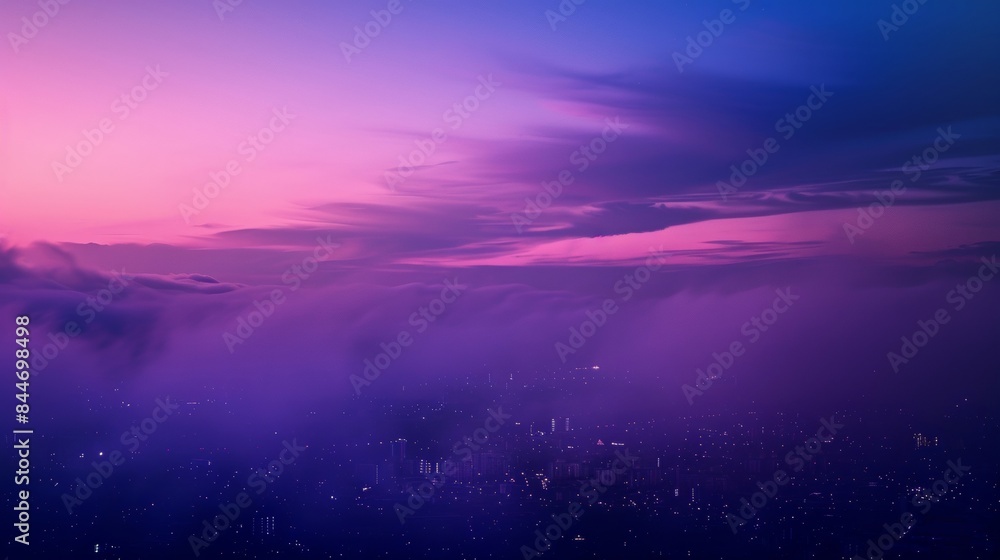 Fototapeta premium The defocused layers of deep purples and blues create a sense of enchantment as the sky fades into the distance highlighting the urban landscape below. .