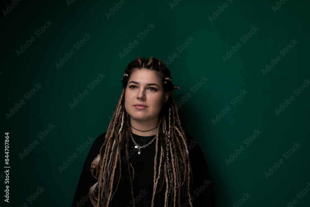 Woman With Dreadlocks Standing in Front of Green Wall Woman With Dreadlocks Standing in Front of Green Wall