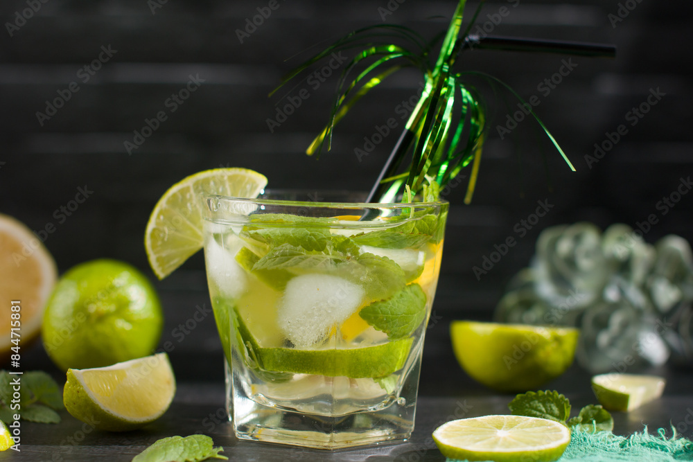 citrus lemon drink with lime in a glass with a straw, mint and ice. Refreshing drink, freshly squeezed refreshing juice citrus lemon drink with lime in a glass with a straw, mint and ice. Refreshing drink, freshly squeezed refreshing juice