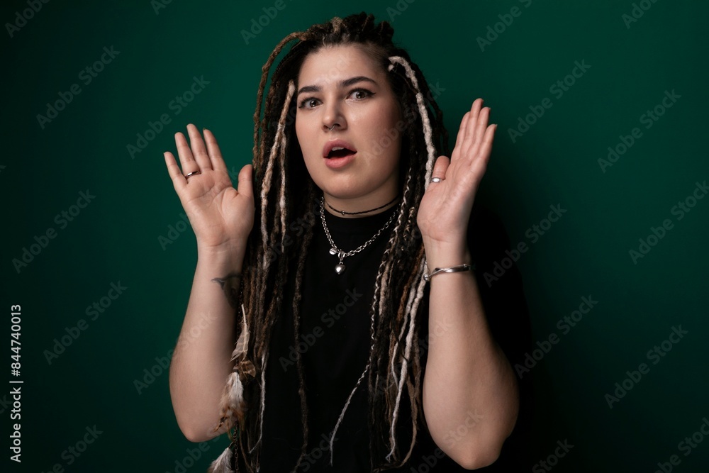 Woman With Dreadlocks Standing in Front of Green Wall Woman With Dreadlocks Standing in Front of Green Wall