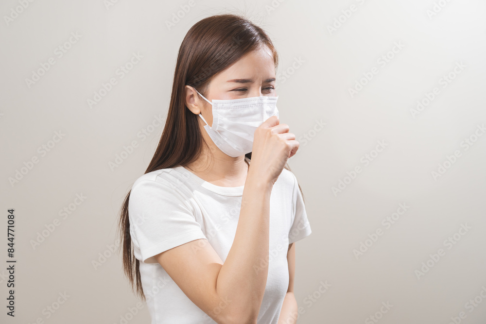 Unhealthy sickness, unwell asian young woman wearing mask coughing, have sore throat, suffering symptom cough feeling bad and healthcare of air pollution and dust, PM2.5 isolated white background. Unhealthy sickness, unwell asian young woman wearing mask coughing, have sore throat, suffering symptom cough feeling bad and healthcare of air pollution and dust, PM2.5 isolated white background.