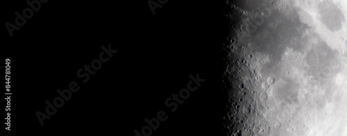 Half moon during the first quarter phase isolated against a black sky.