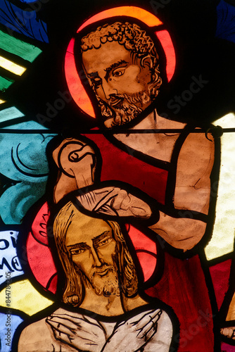 Stained glass representing the baptism of Christ. Vitrail représentant le bâptème du Christ. Annecy - France