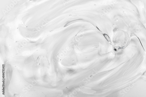 Clear gel serum texture. Liquid skincare cream background. Cosmetic gel product with bubbles close up