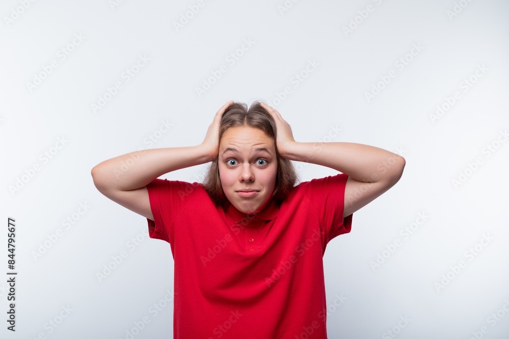 Funny girl with brown hair laughs loudly and holds her head Funny girl with brown hair laughs loudly and holds her head