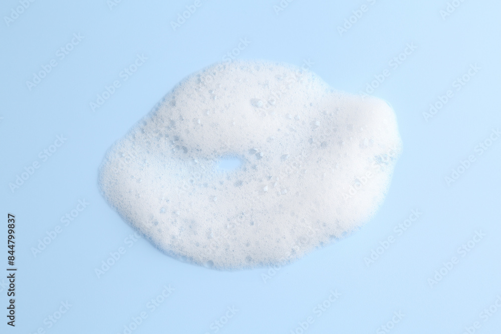 Sample of fluffy foam on light blue background, top view Sample of fluffy foam on light blue background, top view