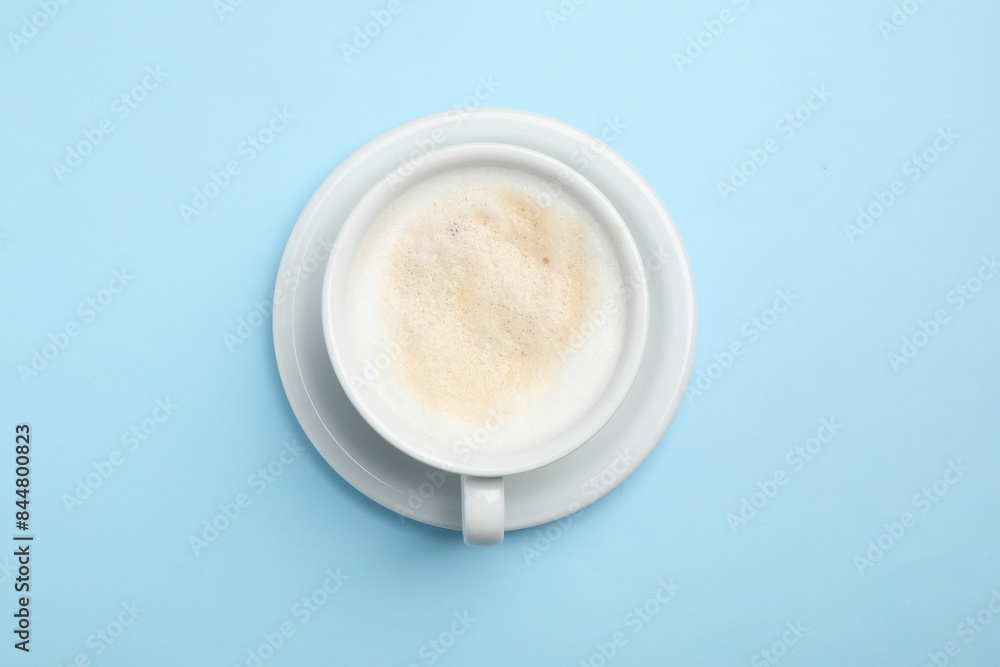 Aromatic coffee in cup on light blue background, top view Aromatic coffee in cup on light blue background, top view