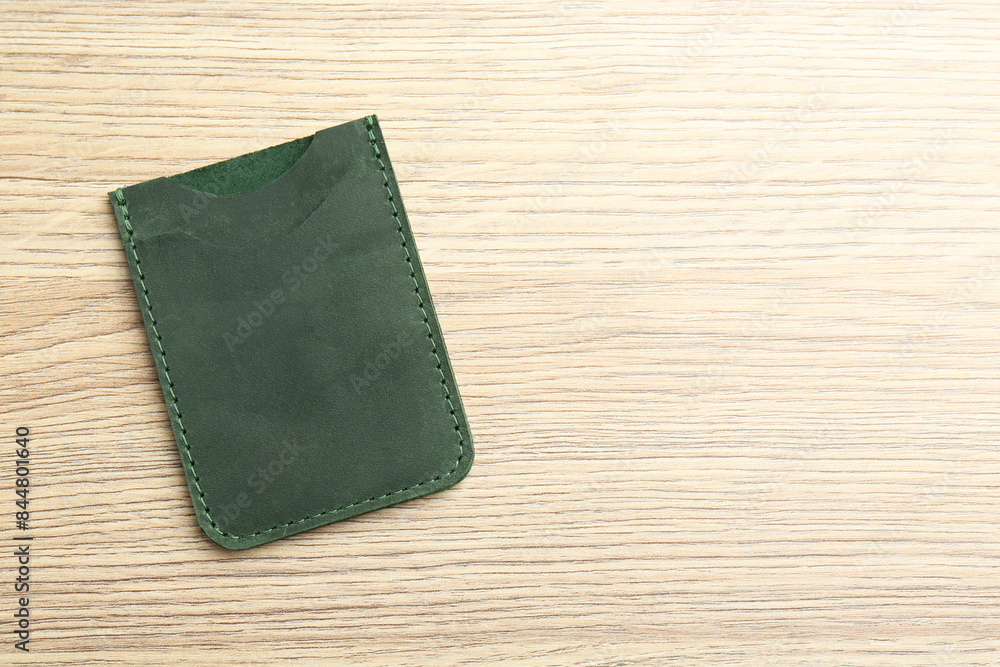 Leather business card holder on wooden table, top view. Space for text Leather business card holder on wooden table, top view. Space for text