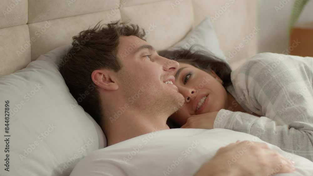 Happy young couple lying together bed bedroom cuddling weekend laziness comfortable man woman girl guy chatting talking smile sweetheart tenderness rest relax homeowner soft lovers relationship tenant Happy young couple lying together bed bedroom cuddling weekend laziness comfortable man woman girl guy chatting talking smile sweetheart tenderness rest relax homeowner soft lovers relationship tenant