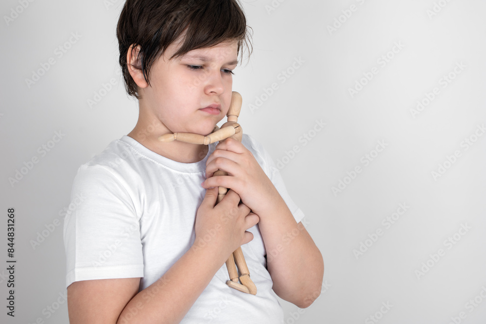 Sad teenager hugs the only friend - wooden man. Depression, anxiety, stress, loneliness and mental health concept