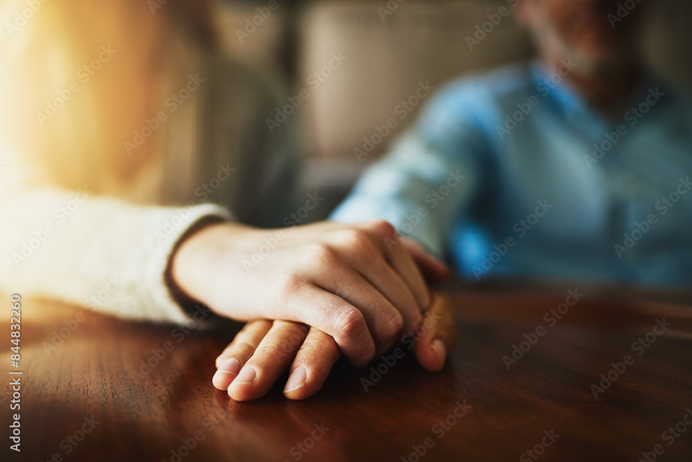 Obraz premium Support, care and trust with hands of people at wooden table together for hope, empathy and love. Anxiety, depression and pain with couple praying in solidarity for peace, help and mental health