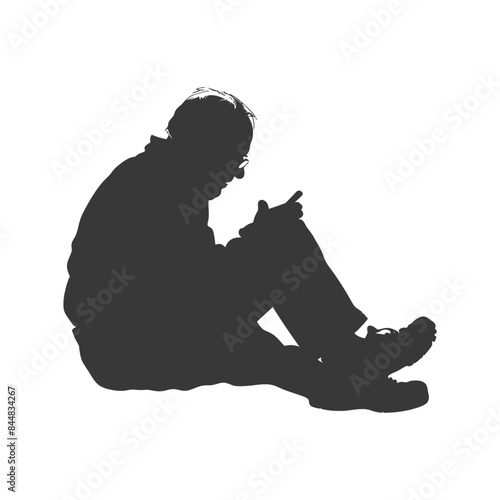 Silhouetted Senior on Ground: Focused on Mobile Device, Casual Pose.