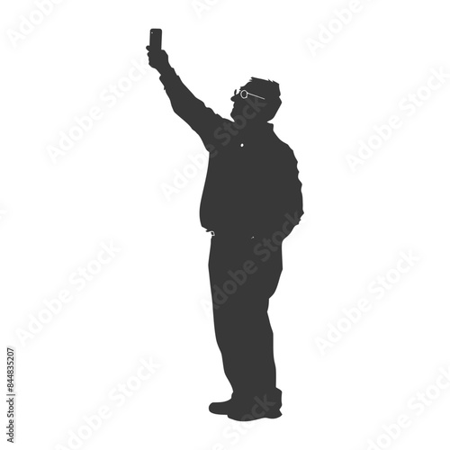 Silhouette: Spectacled man in hat taking selfie, arm extended.