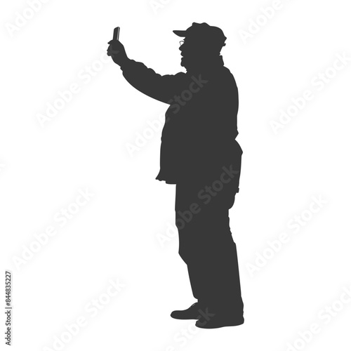 Silhouette of Senior Man Taking Selfie with Phone, Cap and Coat, Side View.