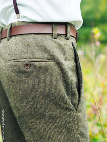 Close-up of Green Textured Pants with Brown Belt Outdoors in Nature Background photo