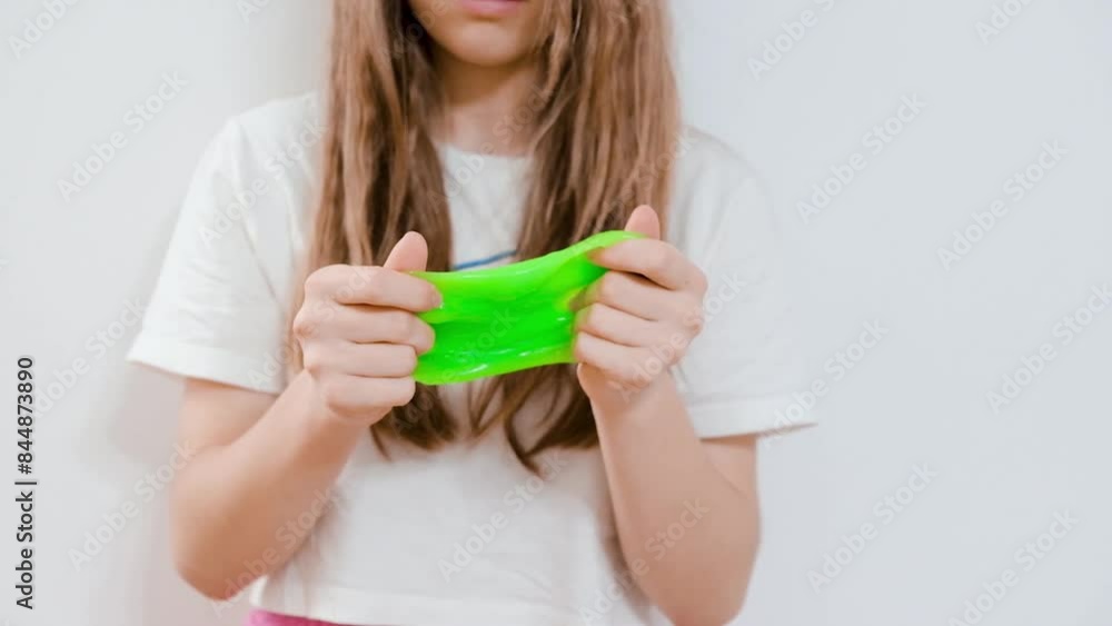 A girl is playing with a slime, creative and fun concept A girl is playing with a slime, creative and fun concept