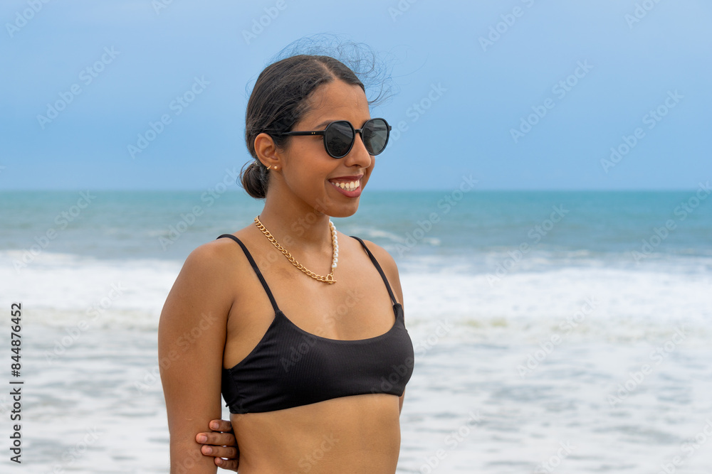 Smiling Woman in Sunglasses and Black Swimsuit on Beach Smiling Woman in Sunglasses and Black Swimsuit on Beach