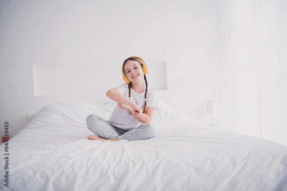 Portrait of positive funny cheerful lovely girl sitting bed morning cozy apartment white light bedroom interior indoors Portrait of positive funny cheerful lovely girl sitting bed morning cozy apartment white light bedroom interior indoors
