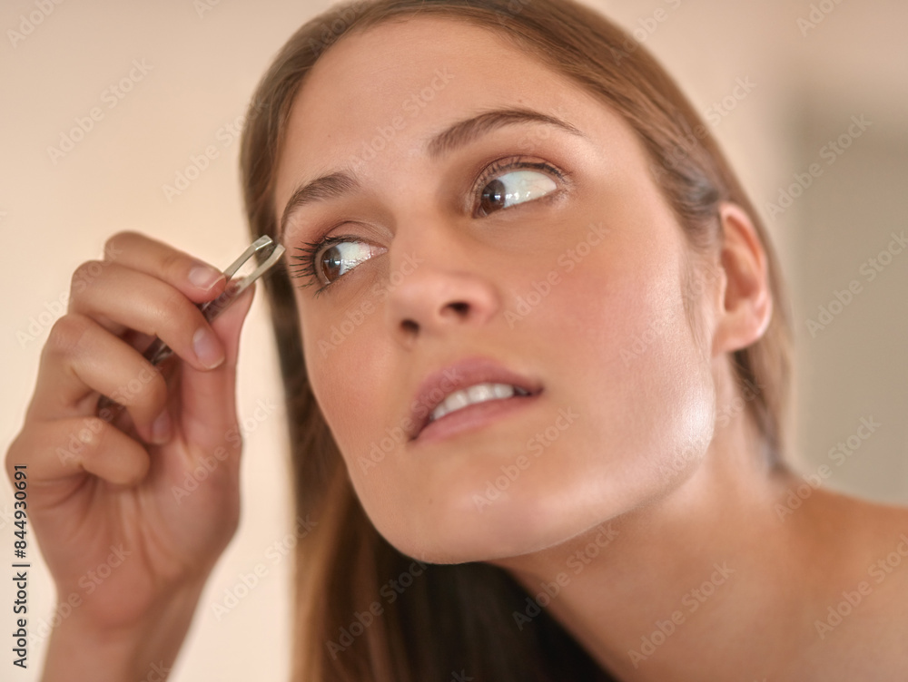 Woman, tweezers and hands by eyebrow in bathroom for beauty, shaping technique and maintenance for facial grooming. Girl, thinking and serious with cosmetic tool for hair removal, hygiene and ideas. Woman, tweezers and hands by eyebrow in bathroom for beauty, shaping technique and maintenance for facial grooming. Girl, thinking and serious with cosmetic tool for hair removal, hygiene and ideas.