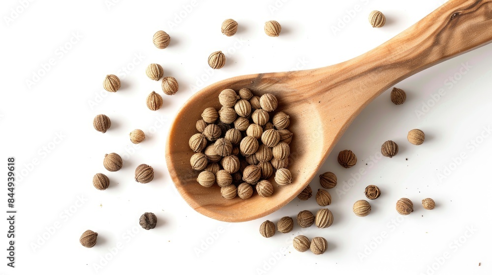 Coriander spice in a wooden spoon on a white background Coriander spice in a wooden spoon on a white background