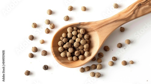 Coriander spice in a wooden spoon on a white background