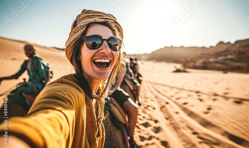 Happy tourist having fun enjoying group camel ride tour in the desert - Travel, vacation activities and adventure concept, Generative AI © Kavita Das