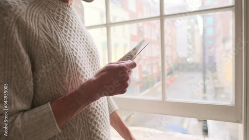 scrupulous young bald man in glasses counts British pounds sterling, gbp front large English vintage window, money counting, currency exchange, financial management, urban living