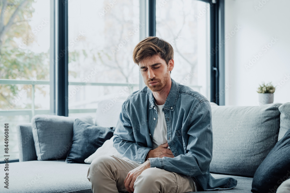 Ταπετσαρία Sick young man in pain holding belly stomach feeling hurt abdomen ache gastritis pancreatitis symptoms or diarrhea, upset adult suffering from indigestion flatulence abdominal problem concept